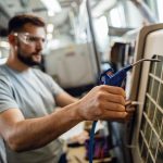 close-up-worker-operating-industrial-machine-factory_637285-4184
